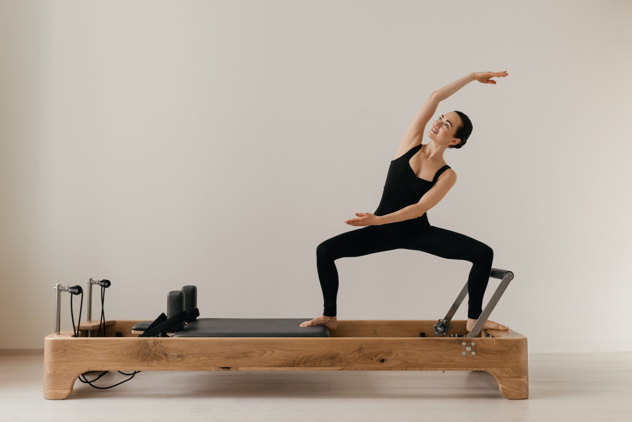 Pilates reformer training machine. sporty woman exercising gym. High quality photo
